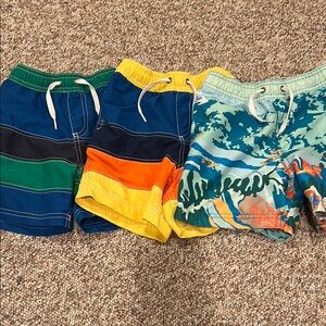 Hanna Andersson Colorblock & Graphic Swim Trunks in Blue, Green, Yellow